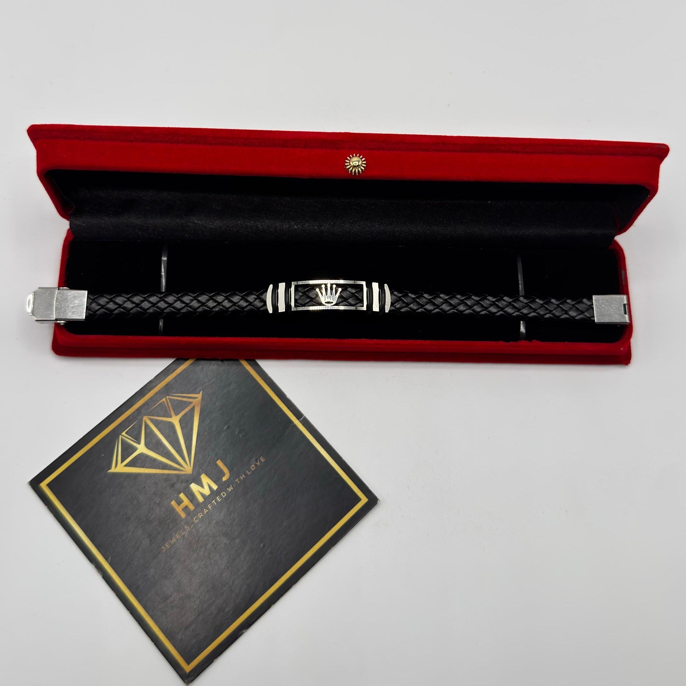 Bracelet in a red case with a black card displaying 'HMJ' on a gray background