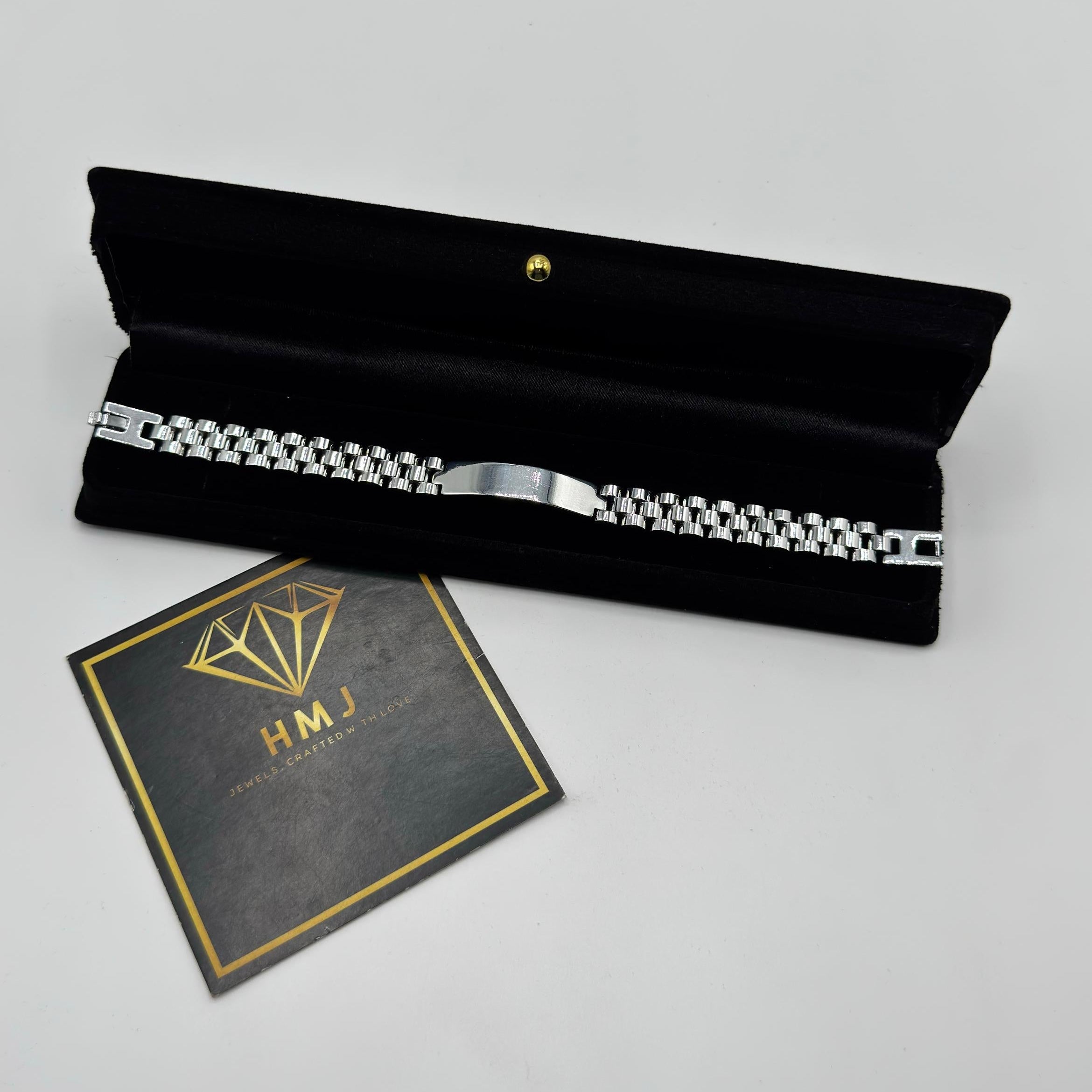 Black pouch with silver zipper and 'HMJ' card on a gray background