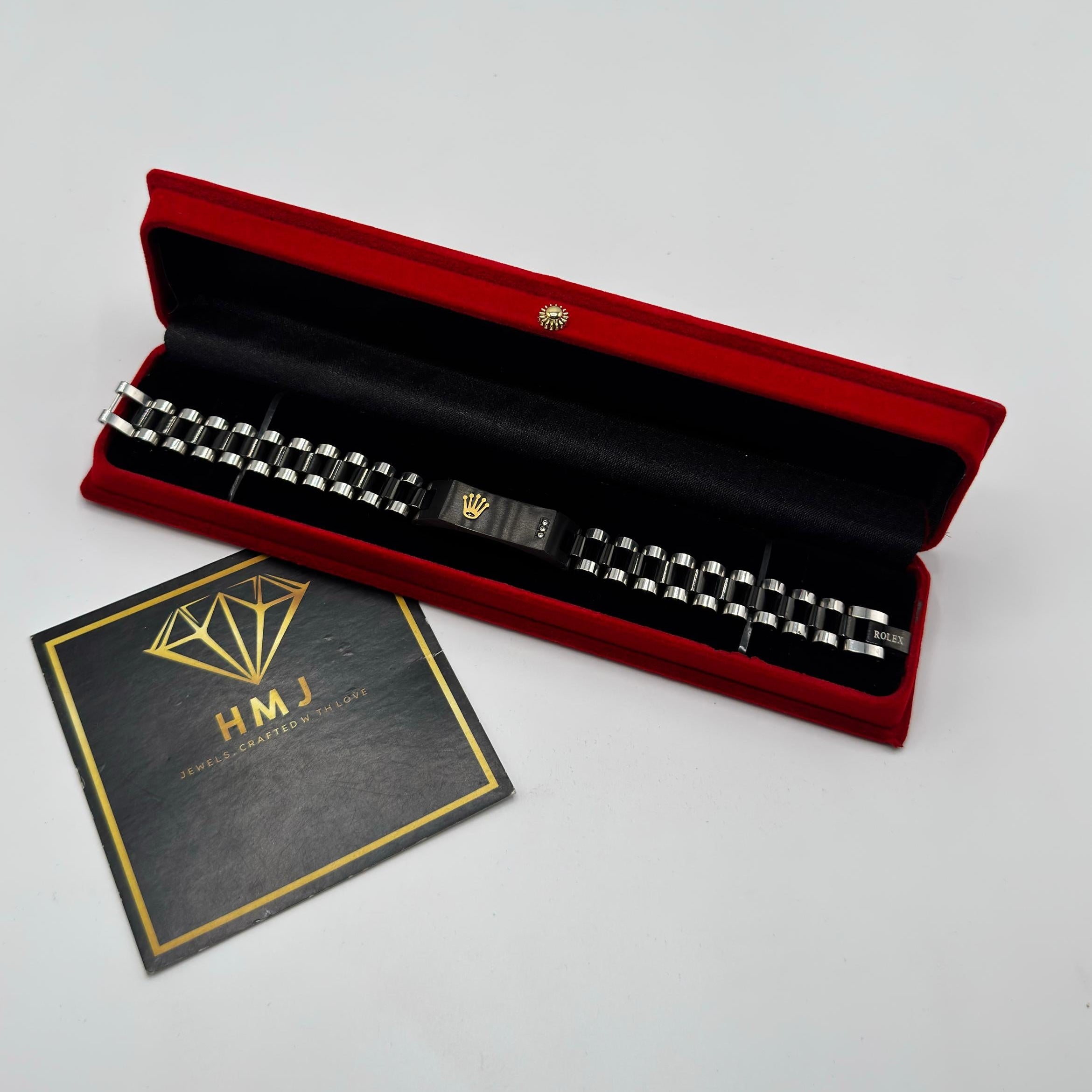 Red jewelry box with a necklace and a card on a gray background