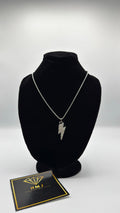 Necklace with a lightning bolt pendant on a black bust, accompanied by a branded card.