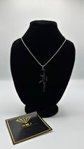 Silver necklace on a black bust with a card displaying 'HMJ' on a white background
