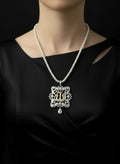 Necklace with a decorative Allah Name pendant on a black bust against a white background